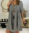 Black Nova V-Neck Tassel Detail Mini Dress by Lumina Wear, featuring a stylish V-neck and tassel accents.