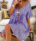 Black Nova V-Neck Tassel Detail Mini Dress by Lumina Wear, showcasing a stylish mini dress with tassel accents and V-neck design.