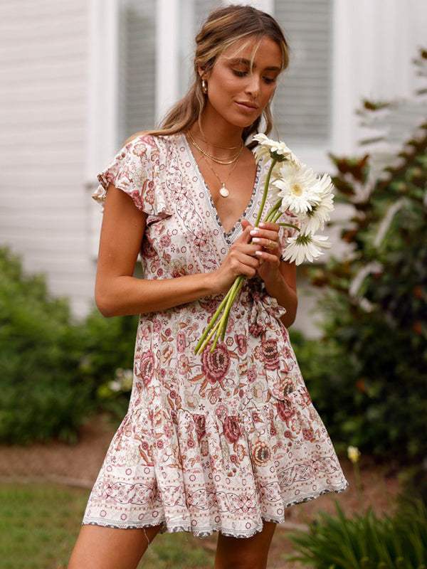 Blue floral print Gwyn wrap mini dress by Lumina Vancouver, featuring a stylish and feminine design.