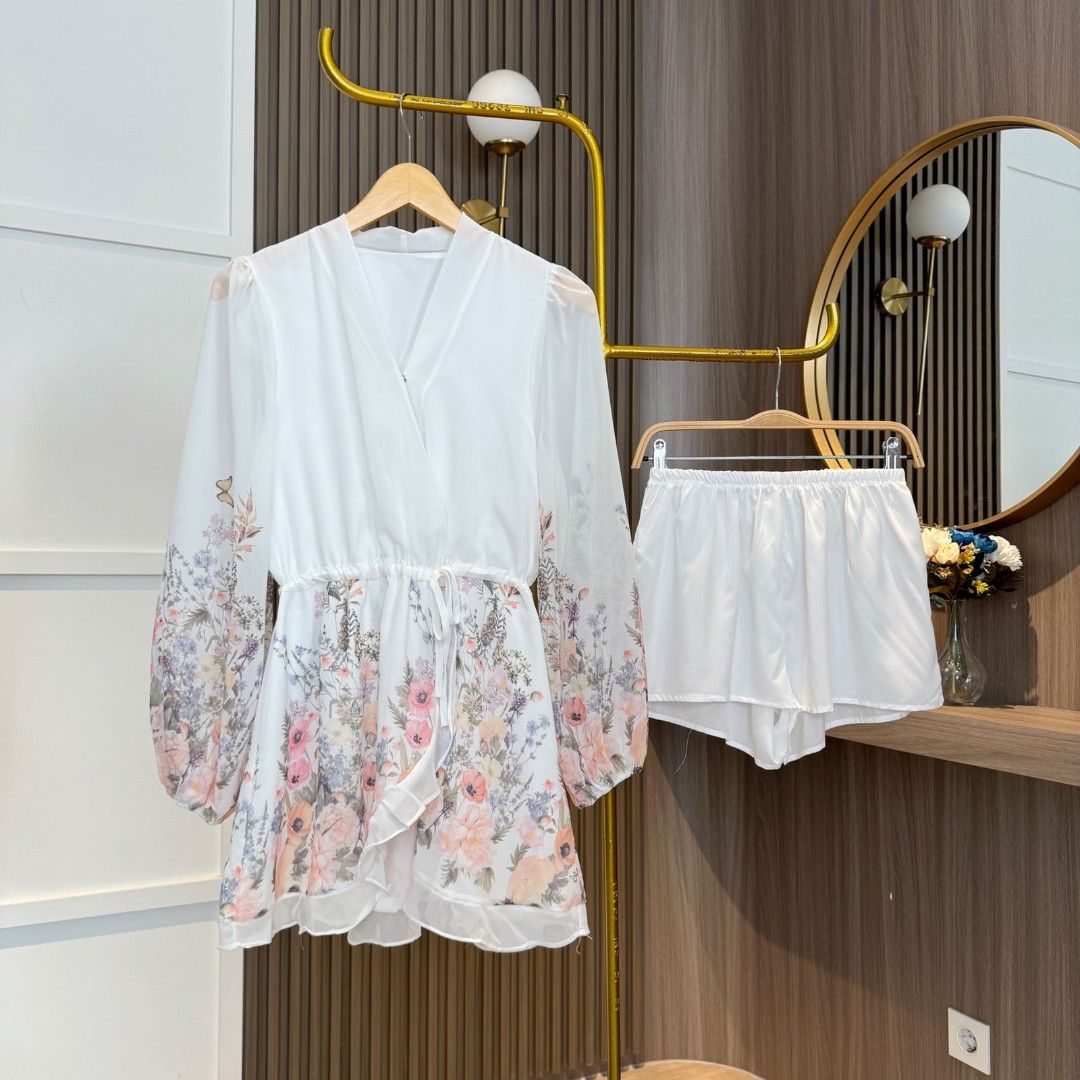 White Faustina floral mini dress with V-neck by Lumina Vancouver, featuring a lightweight, flowy design and vibrant floral pattern.
