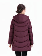 Dark green Olivia women's puffer coat by Lumina Wear featuring a longline hooded design with quilted pattern and cozy padding.