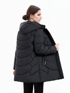Dark green Olivia Lumina women's longline hooded puffer coat with quilted design, cozy and stylish for cold weather.