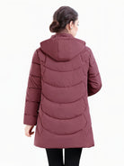 Dark green Olivia longline hooded puffer coat with quilted design by Lumina Wear, women's winter coat with cozy, stylish insulation.