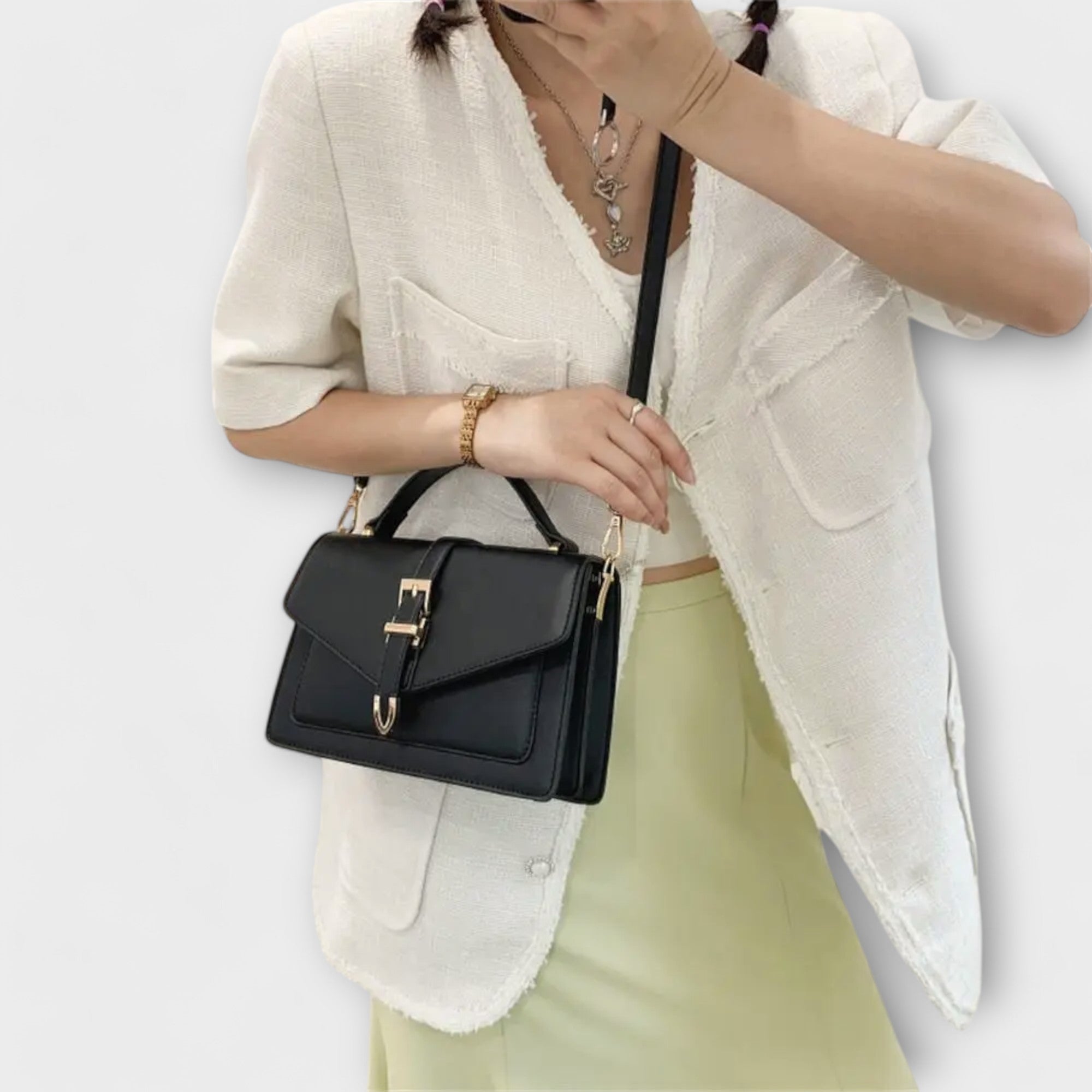 Olivia Lumina mini satchel handbag in khaki with timeless buckle detail, compact size, and elegant design.