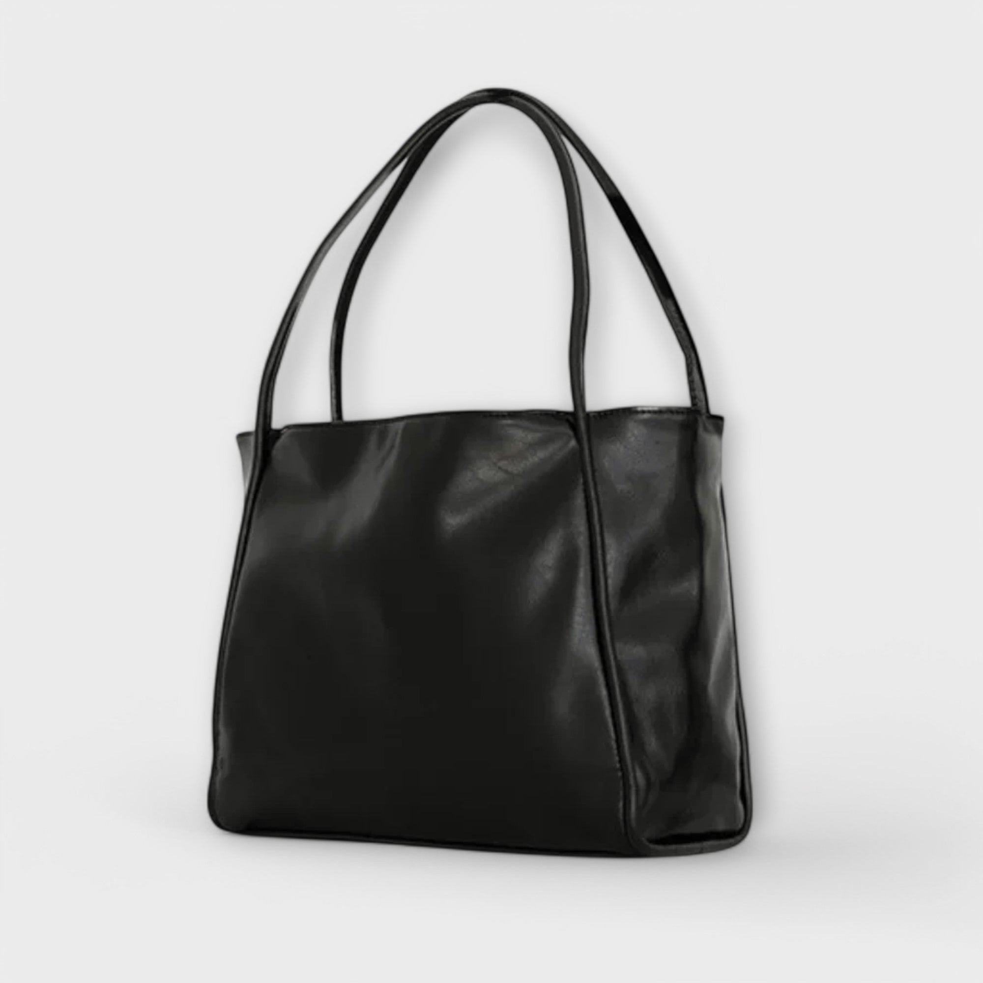 Black Olivia tote bag by Lumina Wear, featuring a spacious minimalist design and sleek silhouette for everyday use.