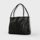 Black Olivia tote bag by Lumina Wear, featuring a spacious minimalist design and sleek silhouette for everyday use.