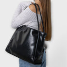Black Olivia tote bag by Lumina Wear featuring a minimalist design and spacious interior, perfect for everyday use.