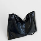 Black Olivia tote bag by Lumina Wear, minimalist design with spacious interior, perfect for everyday use.