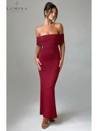 Black Olympia backless maxi dress by Lumina Vancouver, perfect for wedding guests, featuring elegant flowing fabric and a stylish design.