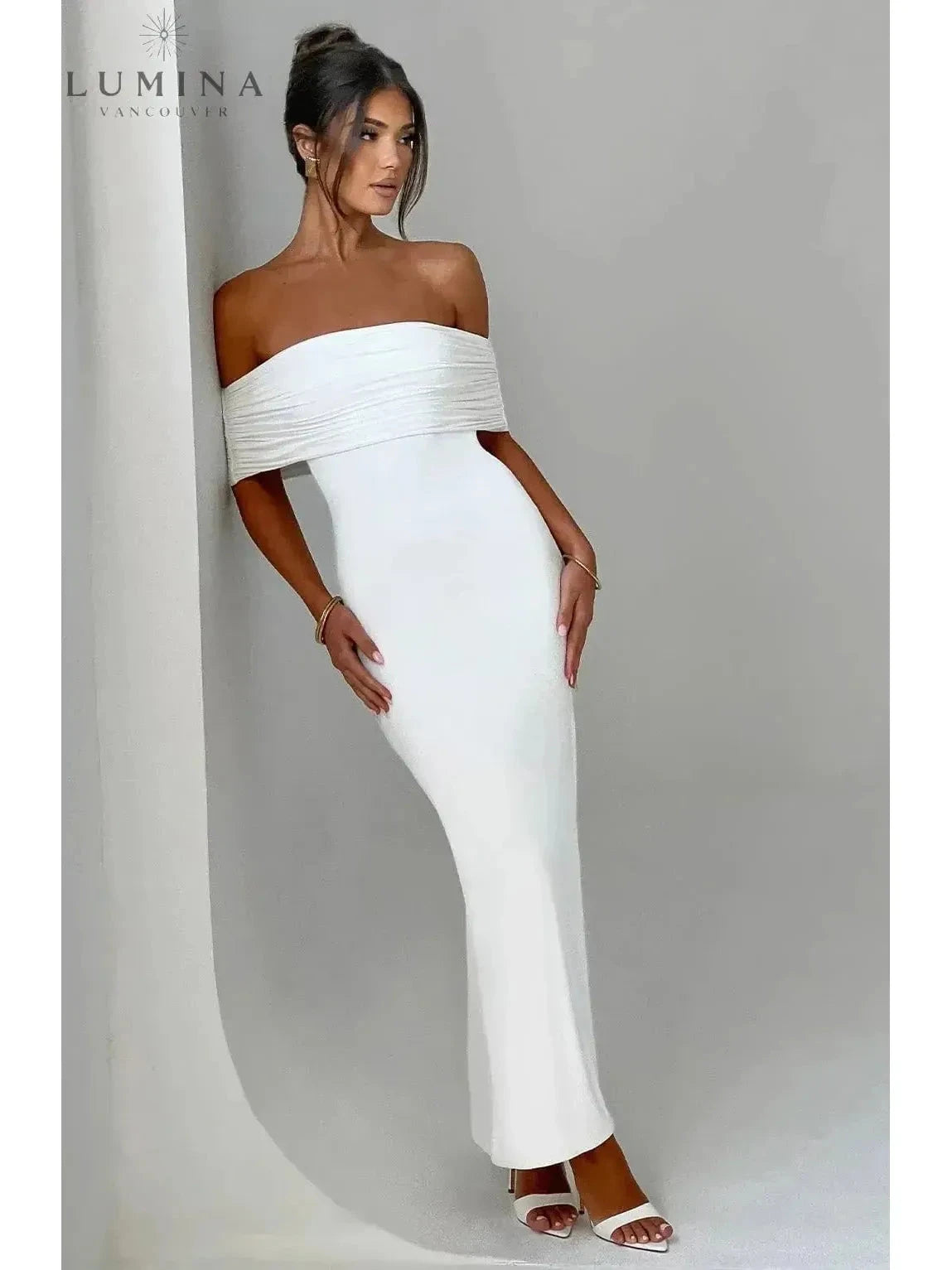 Black Olympia elegant backless maxi dress by Lumina Vancouver, perfect for wedding guests, featuring a flowing silhouette and stylish design.