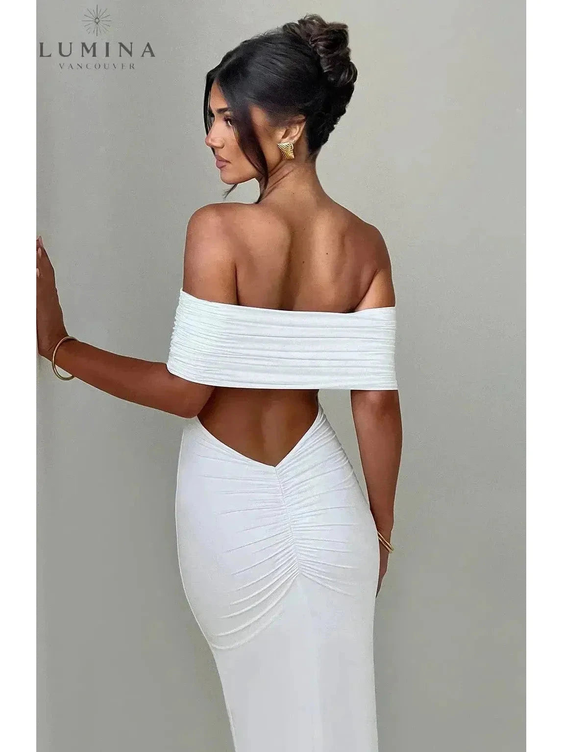 Black Olympia backless maxi dress by Lumina Vancouver, perfect for wedding guests, featuring an elegant, flowing design.