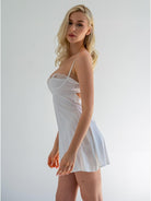White luxurious satin nightdress shaped like a pear, by Lumina Vancouver, with delicate details and smooth fabric.