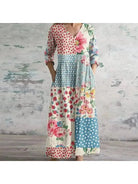 Polly retro maxi dress by Lumina Vancouver featuring vibrant multi-colored floral patterns in red and blue.