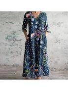 Polly retro maxi dress by Lumina Vancouver with multi-colored floral patterns in red and blue, flowing and stylish for warm weather.