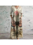 Polly retro maxi dress by Lumina Vancouver featuring vibrant red and blue multi-colored floral patterns and a flowing silhouette.