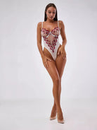 Lumina Vancouver Priya Lace Bodysuit in size S displayed on a hanger with intricate lace details and a fitted silhouette.