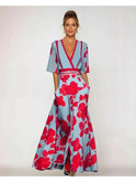 Red floral maxi dress by Lumina Wear featuring a flowing silhouette and vibrant floral pattern, perfect for summer or special occasions.