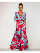 Red floral maxi dress by Lumina Vancouver featuring a flowing silhouette and vibrant floral pattern.