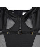 Lumina Vancouver Bettine Bodysuit in black, fitted with long sleeves and scoop neckline, shown on a model.