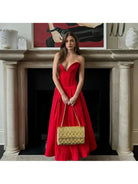 Red Adaline strapless pleated midi dress by Lumina Vancouver, showcasing a sleek design and elegant pleated fabric.