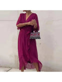 Black Lumina Wear Remi elegant loose dress displayed hanging, showcasing its relaxed fit and stylish design.