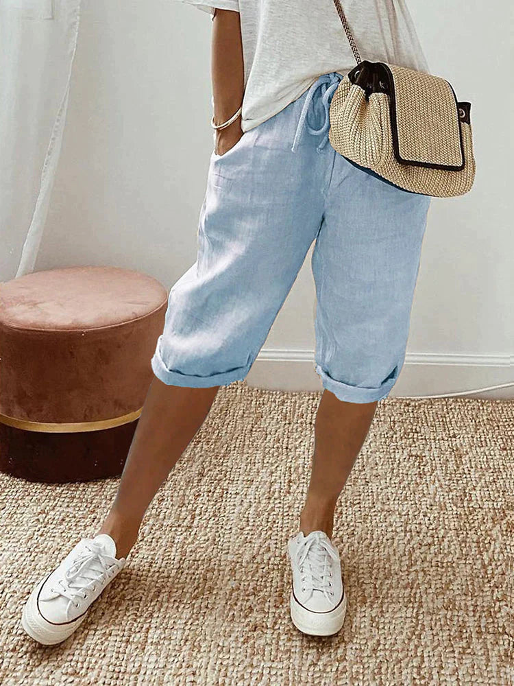 Light beige cotton-linen shorts with a relaxed fit from Lumina Wear, shown in a casual outdoor setting.