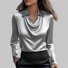 Elegant white women's blouse by Lumina Wear with a draped neckline and long sleeves, perfect for sophisticated fashion.