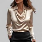 White women's blouse by Lumina Wear featuring an elegant draped neck and long sleeves, perfect for sophisticated style.