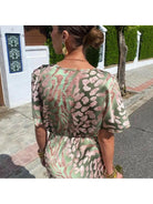 Lumina Vancouver Roxane long dress with twist V-neck, featuring elegant design and flowing fabric, shown on a model.