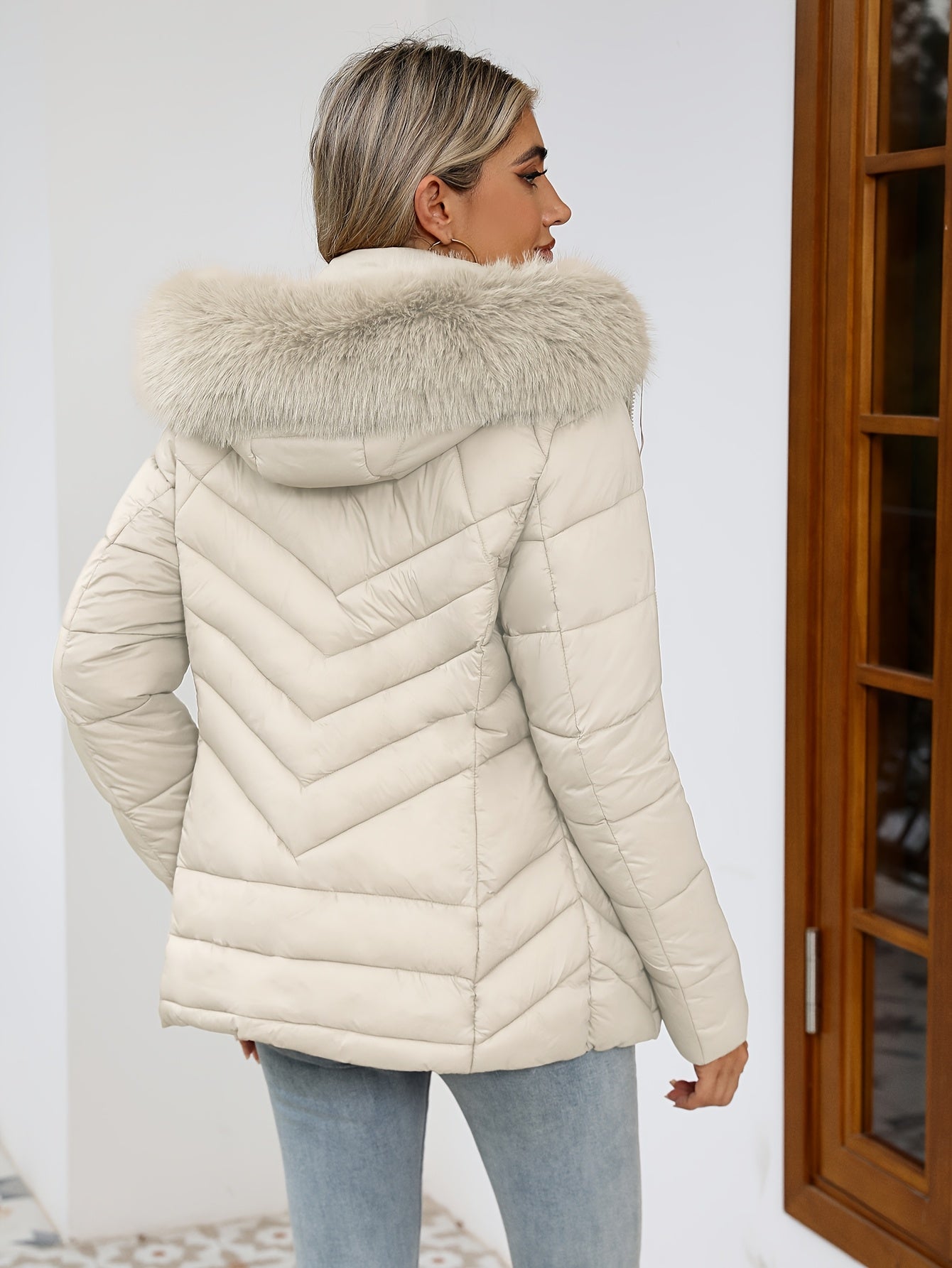 Black women's Ruby quilted puffer jacket with faux-fur hood by Lumina Wear, featuring a cozy, insulated design and stylish fit.