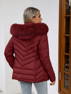 Black women's Ruby cozy quilted puffer jacket with faux-fur hood by Lumina Wear, featuring a fitted style and plush collar.