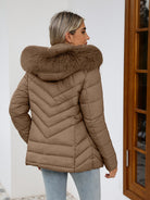Women's Ruby quilted puffer jacket with faux-fur hood by Lumina Wear in black, showcasing cozy quilted design and plush fur trim.