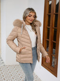 Black Lumina Wear Ruby cozy quilted puffer jacket with faux-fur hood, shown on a woman, featuring a stylish, insulated design.