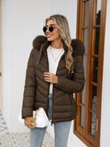 Black Lumina Wear Ruby quilted puffer jacket with faux-fur hood, designed for women, showcasing its cozy, stylish winter coat.
