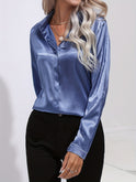 Blue Sarah blouse by Lumina Wear features a button-down front and long sleeves, perfect for elegant, stylish office wear.