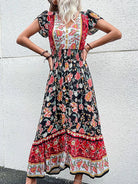 Green Kesa Bloomfield midi dress by Lumina Vancouver, shown on a model, featuring a stylish, flowy design perfect for elegant occasions.