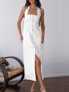White Suvi halter neck maxi dress by Lumina Vancouver, featuring a flowing design perfect for elegant occasions.