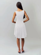 White satin finish mini dress by Lumina Vancouver, featuring a sleek, fitted silhouette and elegant design for stylish occasions.
