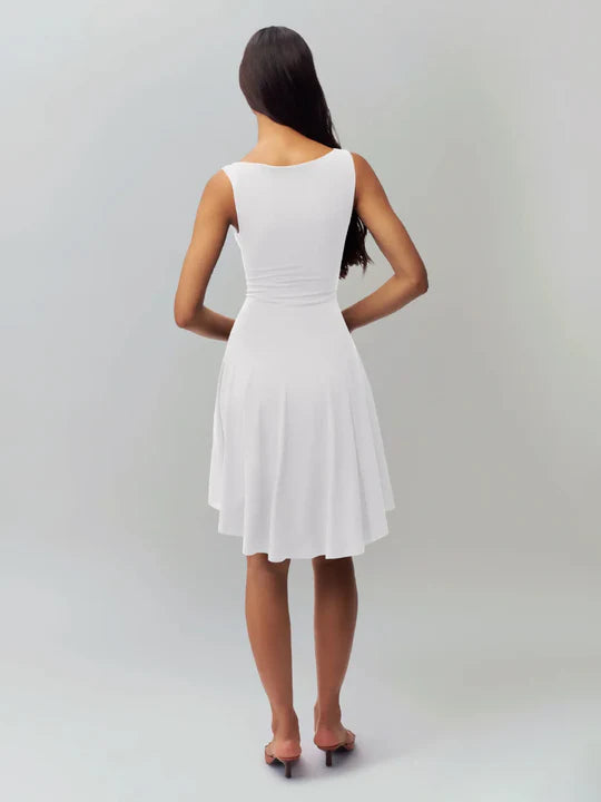 White satin finish mini dress by Lumina Vancouver, featuring a sleek, fitted silhouette and elegant design for stylish occasions.
