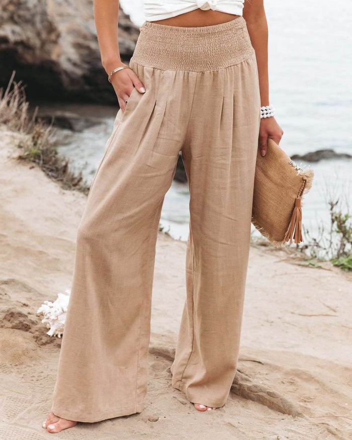 White wide-leg trousers from Lumina Wear featuring a breathable fabric and elastic waistband, styled for a relaxed fit.