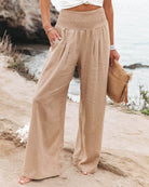 White wide-leg trousers from Lumina Wear featuring a breathable fabric and elastic waistband, styled for a relaxed fit.