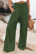 Lumina Wear Serena white wide-leg trousers with breathable fabric and elastic waist, shown in size XS on model.