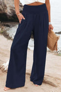 Serena white wide-leg trousers from Lumina Wear featuring breathable fabric and elastic waist, shown in khaki color.