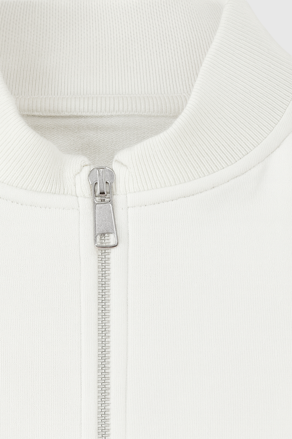 White Serena lounge set by Lumina Wear featuring casual chic style with modern zipper details, perfect for comfortable loungewear.