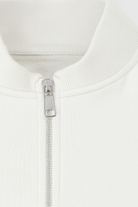 White Serena lounge set by Lumina Wear featuring casual chic style with modern zipper details, perfect for comfortable loungewear.