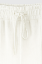 Serena white lounge set by Lumina Wear featuring casual chic style with modern zipper details, perfect for comfortable loungewear.