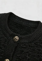 Black knit cardigan with open front by Lumina Wear, styled for women, featuring a cozy and relaxed fit.