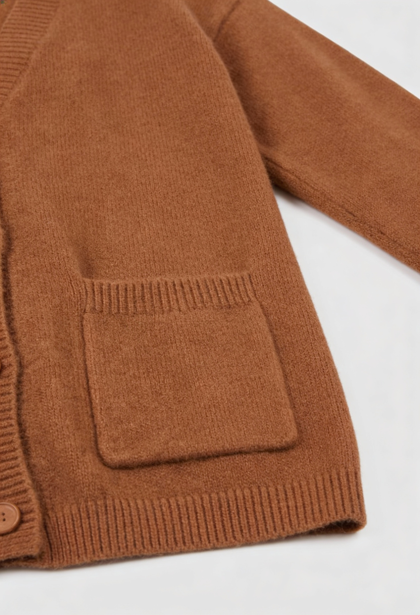 Brown knit cardigan from Lumina Wear featuring a cozy, relaxed fit for women, shown on a model in a casual setting.