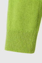 Light green Lumina Wear Serena women's V-neck sweater with a cozy fit, featuring a flattering silhouette and soft knit texture.