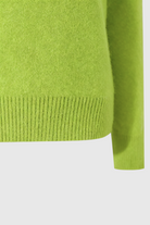 Light green Lumina Wear Serena women's V-neck sweater with a cozy, flattering fit, displayed on a plain background.